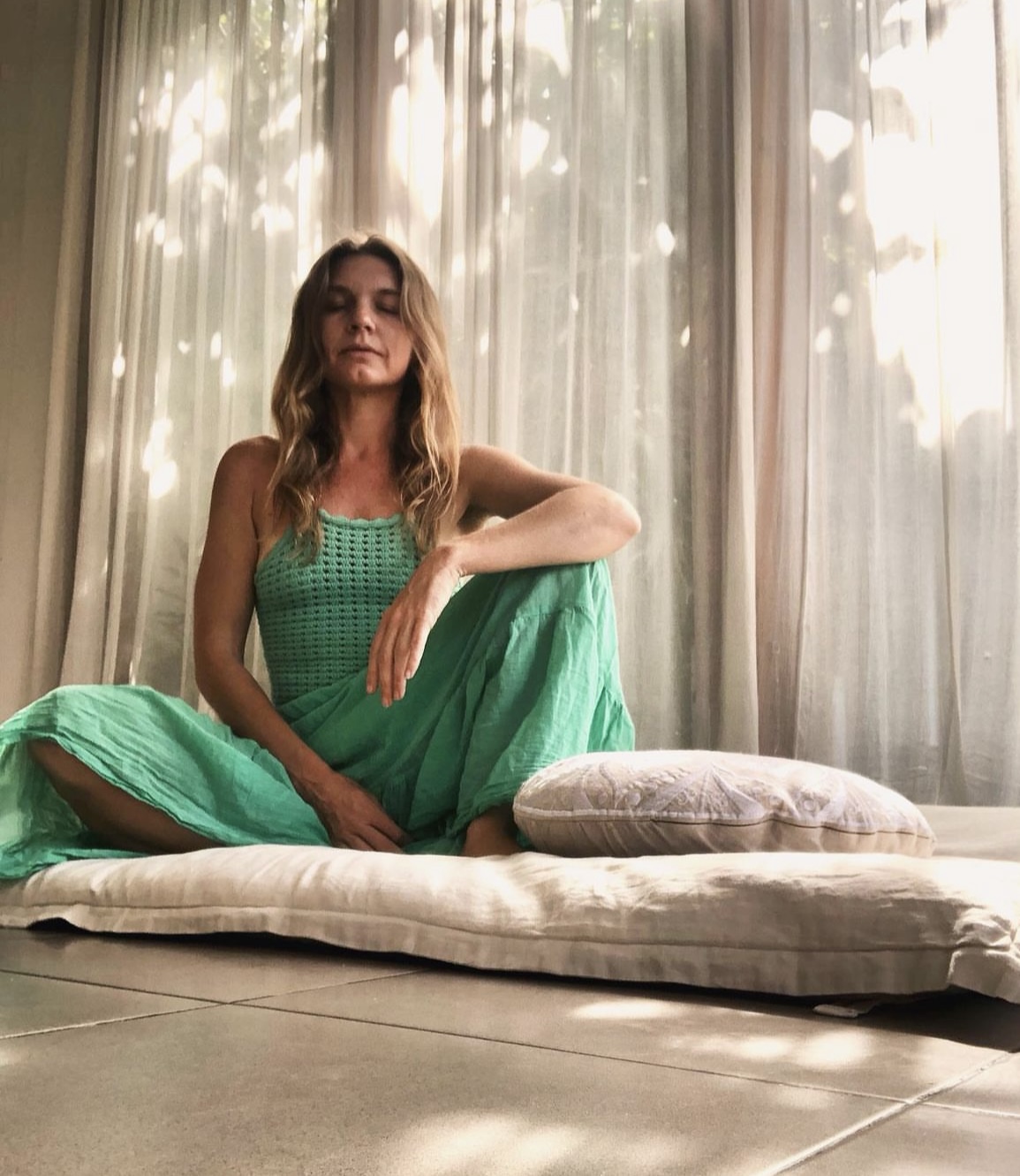 A student seated in stillness, in practice